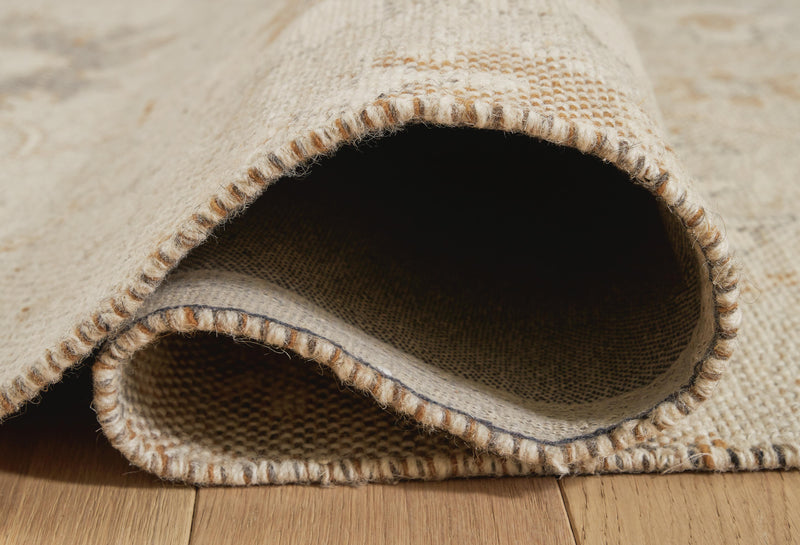 Close-up of Ashley Furniture Calkin Rug with detailed woven pattern in neutral tones.