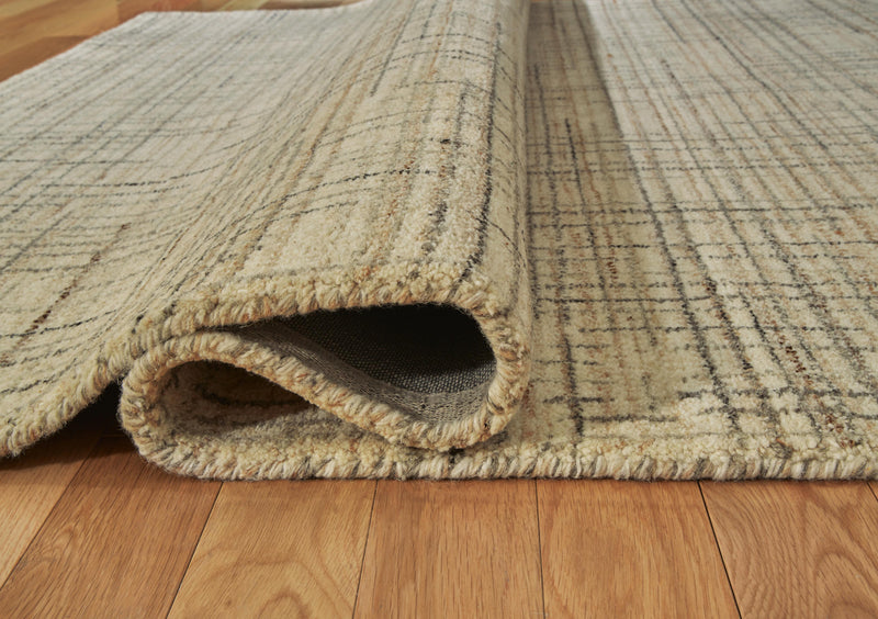 Close-up of Ashley Furniture Janston Rug showing its textured, woven design in neutral tones.