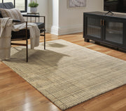 Ashley Furniture Janston Rug featuring a plush, textured design in neutral tones, perfect for adding warmth to any room.