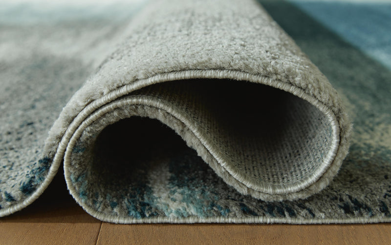 Close-up of Ashley Furniture Brentward Rug showing detailed woven pattern and rich texture in neutral tones.