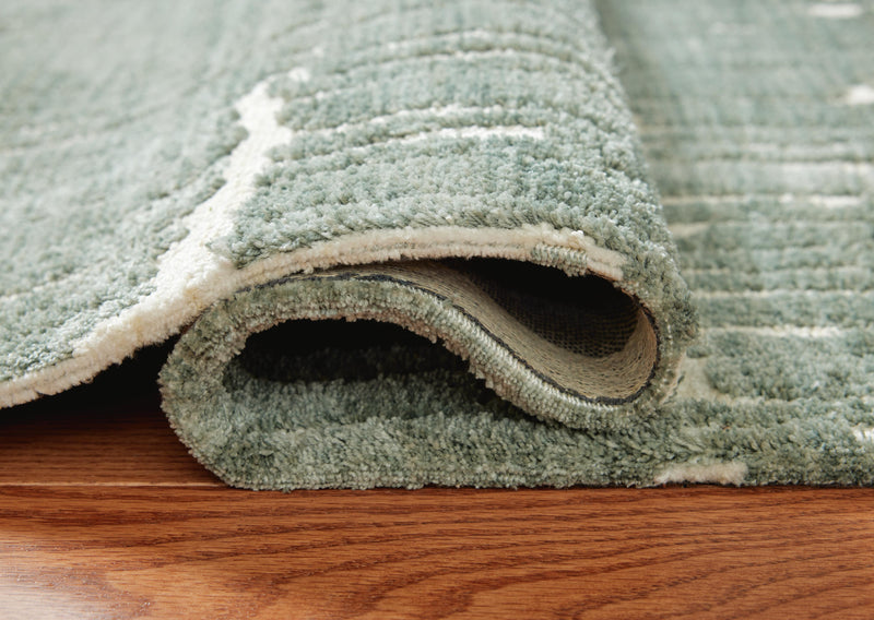 Close-up of the Ashley Furniture Cayworth Rug showing intricate pattern and soft texture in neutral tones.
