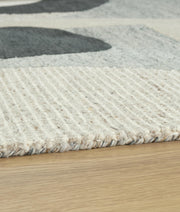 Medium 5x7 rug by Ashley Furniture featuring intricate patterns and warm tones, perfect for adding style to living spaces.