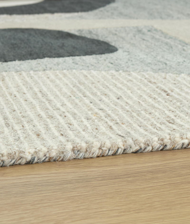 Medium 5x7 rug by Ashley Furniture featuring intricate patterns and warm tones, perfect for adding style to living spaces.
