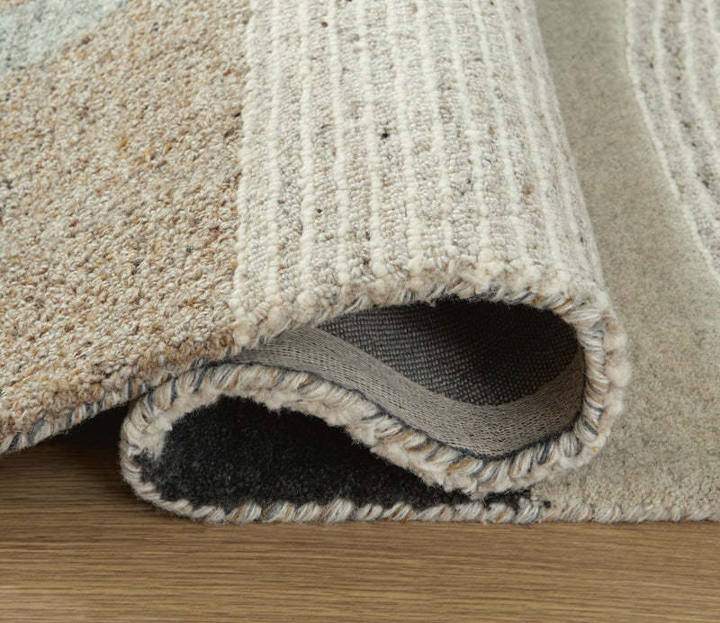 Medium Ashley Furniture Edrickhill 5' x 7' rug with detailed pattern, showcasing soft fibers and elegant design.