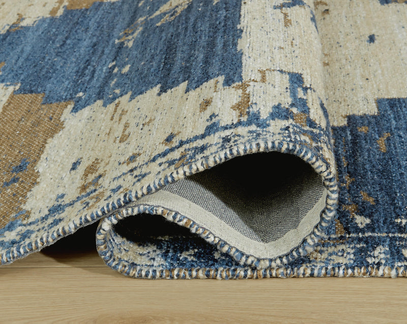 Close-up of Ashley Furniture Varnler Rug with intricate patterns and warm tones, showcasing the detailed design of the rug.