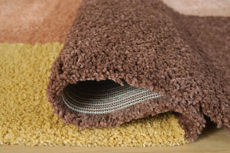 Close-up of the Gailmore Rug by Ashley Furniture, showing detailed woven pattern and soft texture on a neutral background.