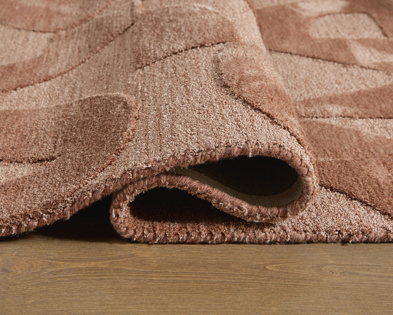 Close-up of the Ashley Furniture Perrenton rug showing detailed woven pattern and rich texture in a natural indoor setting.