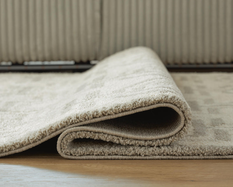Close-up of the Maconville Medium Rug from Ashley Furniture, showcasing its detailed woven pattern and soft texture.
