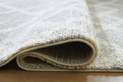 Ashley Furniture Unawick Medium Rug showing detailed woven pattern in neutral tones, ideal for living room or bedroom decor.