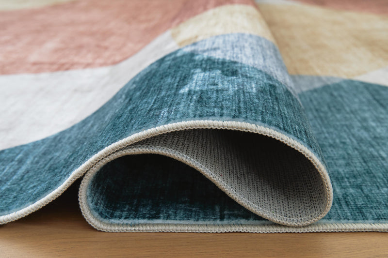 Large Ashley Furniture Chanleigh washable area rug, 7'6" x 9'6", with detailed pattern and soft texture in neutral tones.
