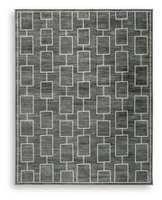 Large Ashley Furniture Elderland washable area rug, 7'6" x 9'6" with intricate pattern and soft texture, perfect for living spaces.