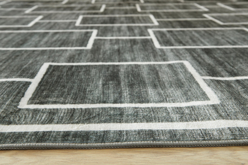 Large Ashley Furniture Elderland washable area rug, 7'6" x 9'6", with detailed pattern and soft texture, suitable for living rooms and bedrooms.