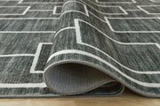 Large Ashley Furniture Elderland washable area rug, 7'6" x 9'6" with detailed woven pattern in neutral tones.