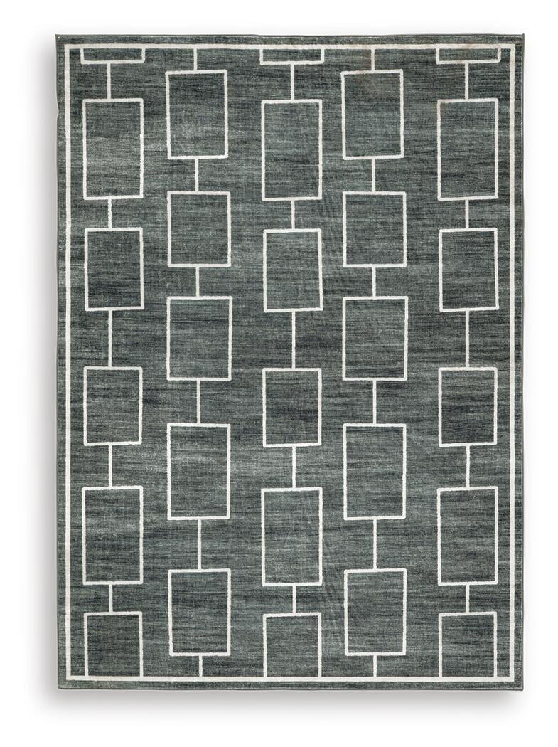 Medium Ashley Furniture Elderland washable 5' x 7' area rug with a soft, patterned design on a neutral background.