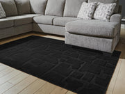 Medium Ashley Furniture Gibbswell washable 5x7 area rug with a detailed pattern, perfect for living rooms and bedrooms.