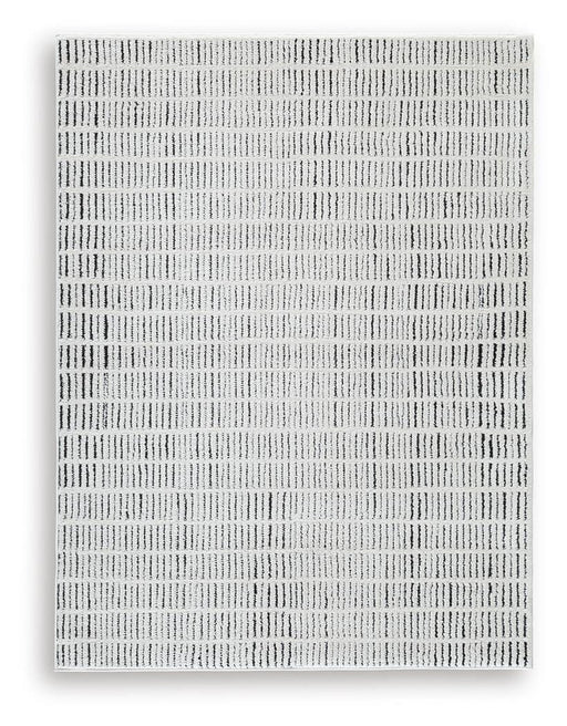 Ashley Furniture Turinwith area rug with intricate patterns in neutral tones, ideal for living room or bedroom decor.
