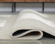 Large Ashley Furniture Wolbert 7'8" x 10' area rug with intricate patterns and soft texture, perfect for living rooms or bedrooms.