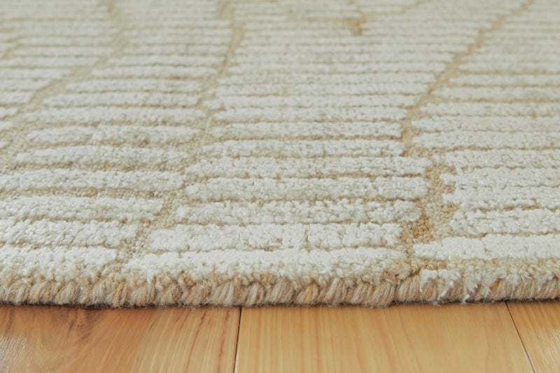 Close-up of the Ashley Furniture Jaseena Area Rug showing intricate pattern and soft texture in neutral tones.