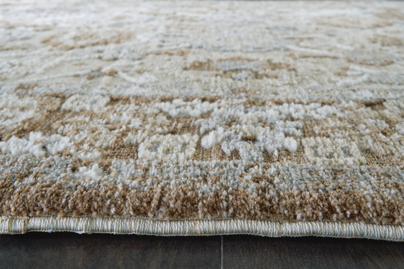 Close-up of Ashley Furniture Ainswick Memory Foam Rug showcasing soft, plush texture and detailed design on a neutral background.