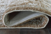 Close-up of Ashley Furniture Ainswick Memory Foam Rug showcasing its plush texture and detailed weave pattern.