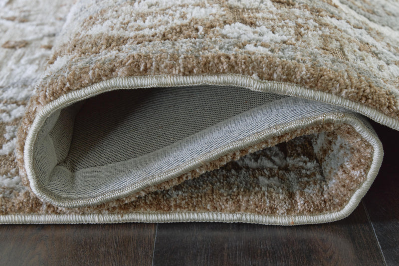 Close-up of Ashley Furniture Ainswick Memory Foam Rug showcasing its plush texture and detailed weave pattern.