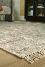 Close-up of Rossbury Rug by Ashley Furniture, showcasing intricate woven pattern and soft, textured surface.