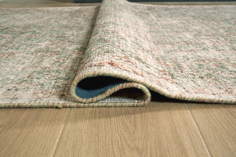Close-up of the Ashley Furniture Rossbury Rug, showcasing its detailed woven pattern and rich texture.