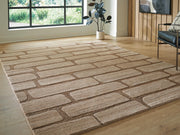 Ashley Furniture Orest Rug with intricate geometric patterns in neutral tones, shown in a cropped view.