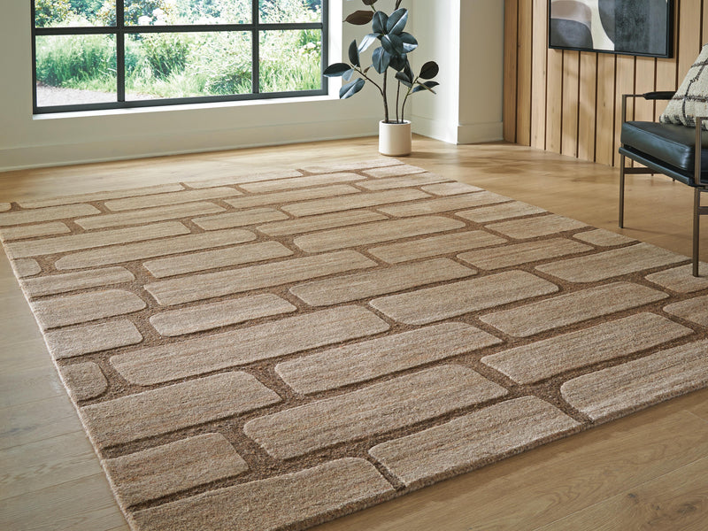 Ashley Furniture Orest Rug with intricate geometric patterns in neutral tones, shown in a cropped view.