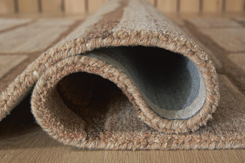 Close-up of Ashley Furniture Orest Rug showing detailed woven pattern and rich texture in neutral tones.