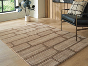 Close-up of the Ashley Furniture Orest Rug featuring a textured, patterned design in neutral tones, cropped for detail.