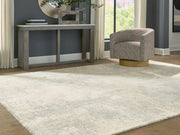 Ashley Furniture Raif Rug, cropped image showing textured beige and brown woven rug with intricate pattern details.