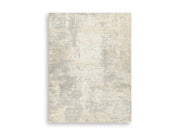 Ashley Furniture Raif Rug with intricate patterns in neutral tones, showcasing plush, woven texture for cozy home decor.