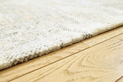 Close-up of Ashley Furniture Raif Rug showcasing its textured woven pattern and neutral color palette.