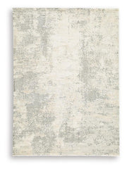 Ashley Furniture Raif Rug with intricate pattern in neutral tones, showcasing plush texture and stylish design for modern interiors.