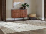 Ashley Furniture Uduak Rug with intricate geometric patterns in warm neutral tones, perfect for cozy living spaces.