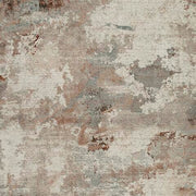 Swatch of Ashley Furniture Jadenburg Rug in neutral tones, showcasing soft woven texture and intricate pattern details.