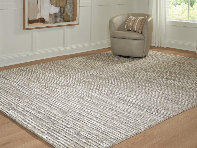 Ashley Furniture Eljory Rug in neutral tones, showcasing a textured woven pattern on a wooden floor.