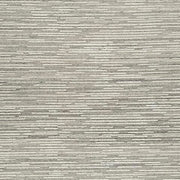 Swatch of Ashley Furniture Eljory Rug featuring a textured design in neutral tones, showcasing soft fabric and intricate pattern.