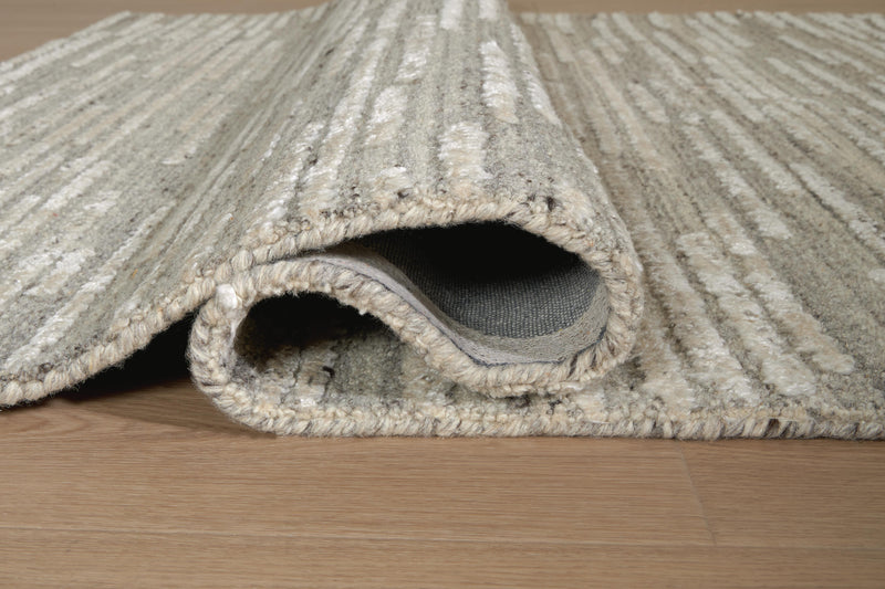 Close-up of the Ashley Furniture Eljory Rug showing its detailed woven pattern and soft texture in natural tones.