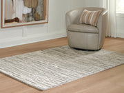 Ashley Furniture Eljory Rug with intricate pattern in neutral tones, cropped view showcasing soft woven texture.