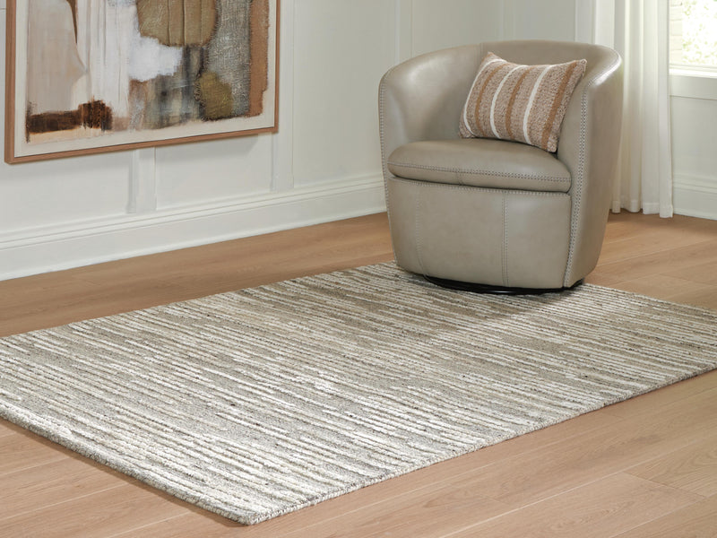 Ashley Furniture Eljory Rug with intricate pattern in neutral tones, cropped view showcasing soft woven texture.
