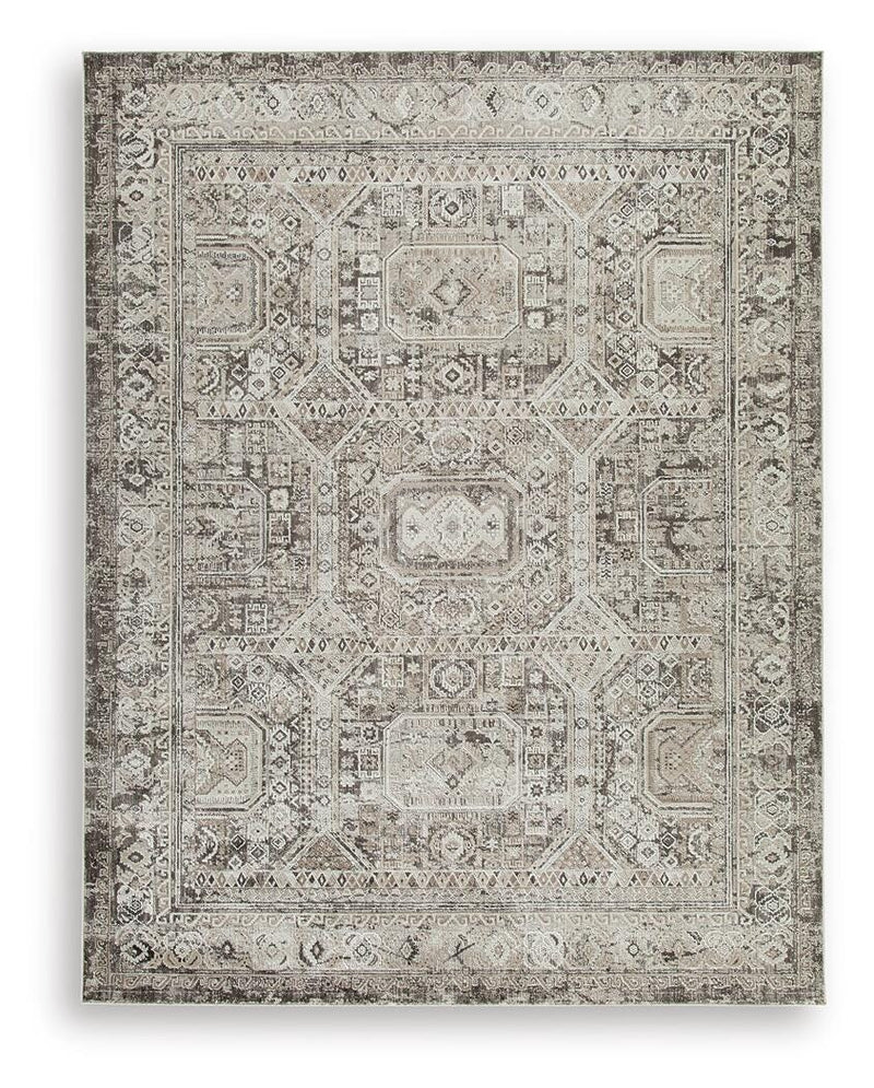 Ashley Furniture Junley Rug with intricate patterns in neutral tones, showcasing soft woven fabric and detailed craftsmanship.