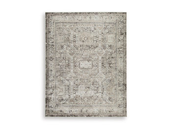 Ashley Furniture Junley Rug featuring a soft, patterned design in neutral tones, perfect for enhancing living room decor.