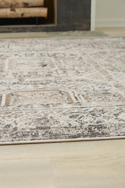 Close-up of a Junley Rug by Ashley Furniture, showcasing its textured, woven design in neutral tones.