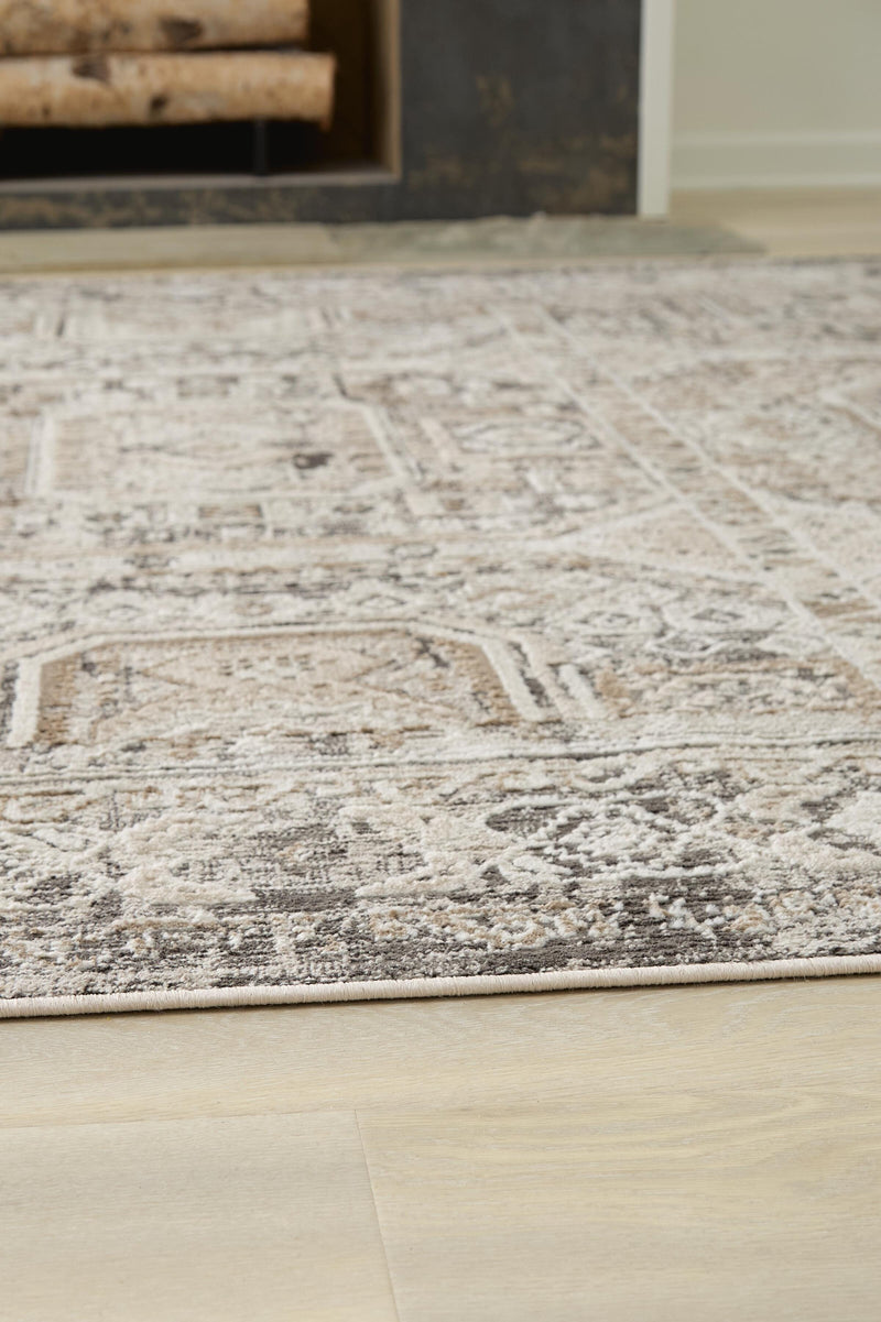 Close-up of a Junley Rug by Ashley Furniture, showcasing its textured, woven design in neutral tones.