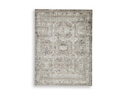 Ashley Furniture Junley Rug featuring a soft, woven design in neutral tones, ideal for adding warmth to living spaces.
