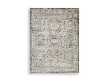 Ashley Furniture Junley Rug featuring a soft, woven design in neutral tones, ideal for adding warmth to living spaces.