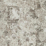 Swatch of Ashley Furniture Barricland Rug with intricate pattern and neutral tones, showcasing soft woven texture and detailed design.