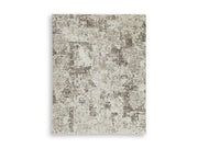 Ashley Furniture Barricland Rug with intricate patterns in warm tones, showcasing a plush, woven texture perfect for living spaces.